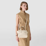 Frontal view: SMALL MARO BAG IN CACHEMIRE LEATHER AND MOSAICO, light cream, worn by model as a shoulder bag and a handbag on the body; woven Mosaico and knotted leather details.
