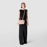 Front view: SMALL MARO BAG IN CACHEMIRE LEATHER AND MOSAICO, antique-rose mini bag, worn diagonally over the shoulder by a model and held by the handles, against a light background.