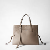 Frontal view: MEDIUM MARO BAG IN CACHEMIRE LEATHER AND MOSAICO presented on a neutral background; Sahara-colored Mosaico on top, pebbled Cachemire leather below, long shoulder strap, side leather knots; 'SERAPIAN' logo on the front.