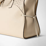 Detail view, MAXI MARO BAG IN CACHEMIRE LEATHER AND MOSAICO: cream grained cachemire leather bag with Mosaico panel, side-knotted nappa leather strip; embossed "Serapian" lettering visible.