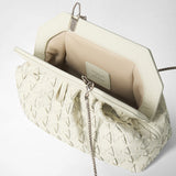 Detail view: MINI SECRET CLUTCH BAG IN MOSAICO MICROCHAIN is open, showing cream-colored Mosaico leather with microchain trim, a light-colored lining, and a fine metal chain. The interior label reads “SERAPIAN MILANO MADE IN ITALY”.