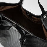 Front view of the VERTICAL SECRET TOTE BAG IN STEPAN, open, showing asphalt gray textured Stepan canvas with black leather handles and spacious interior.