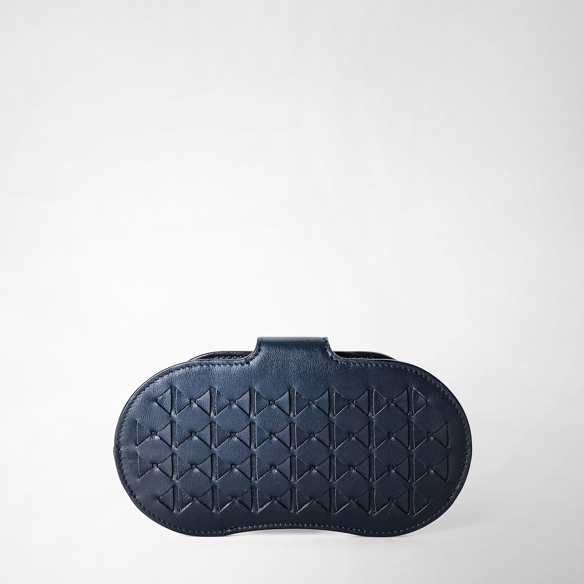 Frontal view of the GLASSES HOLDER IN MOSAICO in navy blue, crafted from woven, graphic-patterned Mosaico leather with a rounded shape and elegant closure.